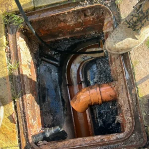 Unblocked Drain in Hampshire with rod in it