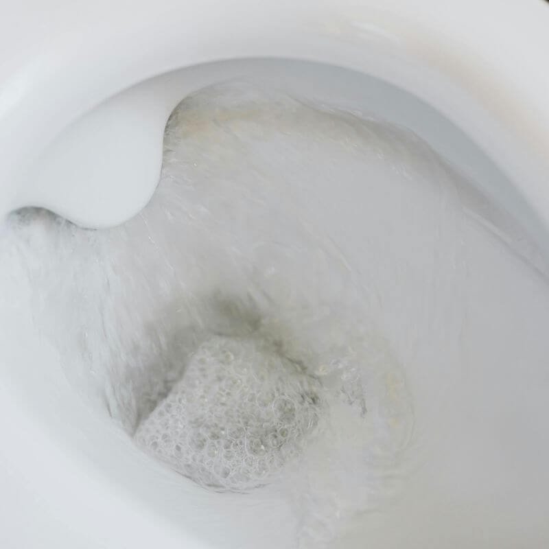 A slow draining toilet flushing