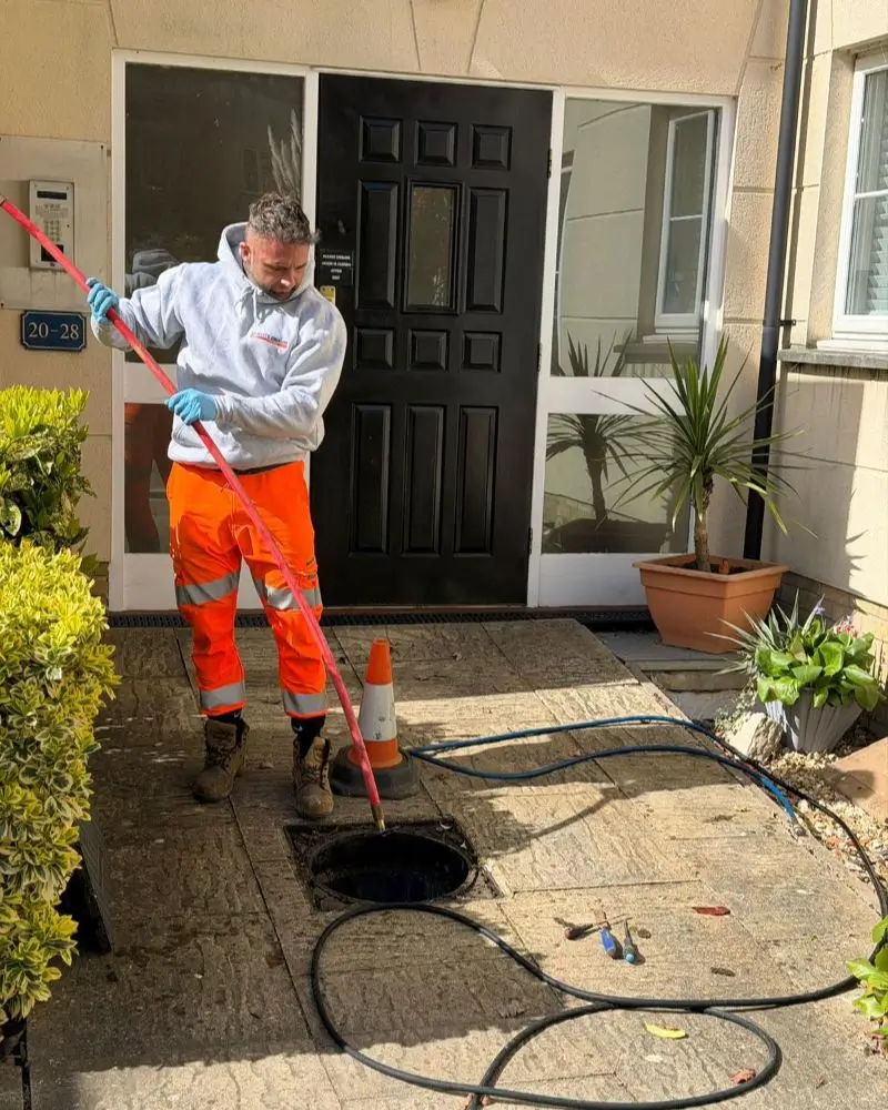 Elite Drains Limited drainage expert unblocking a drain using a drain rod